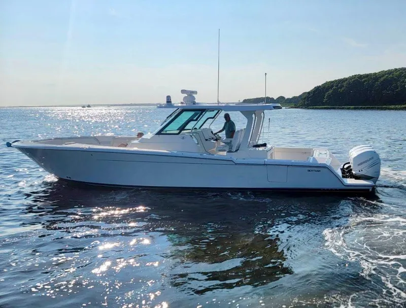 Slide: The Image of 2022 Bertram 39 CC boat cruising on a sunny day in open water. - 4