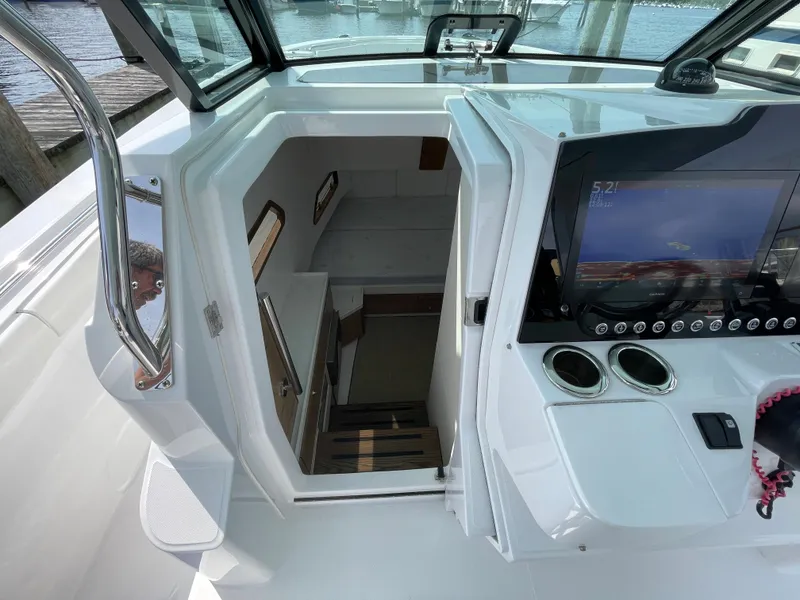 Slide: The Image of Interior view of 2022 Bertram 39 CC boat, featuring cabin entrance and control panel. - 48