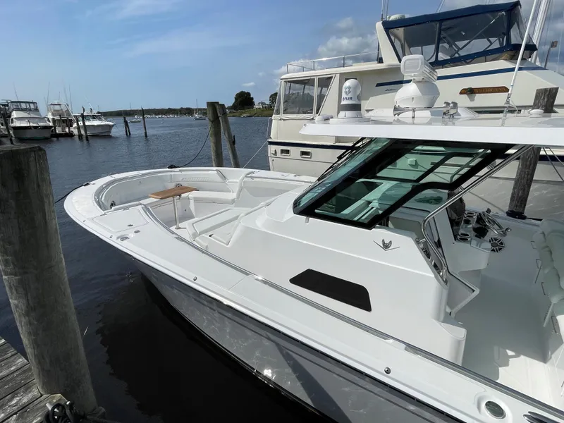 Slide: The Image of 2022 Bertram 39 CC boat docked at marina, showcasing sleek design and spacious deck. - 8