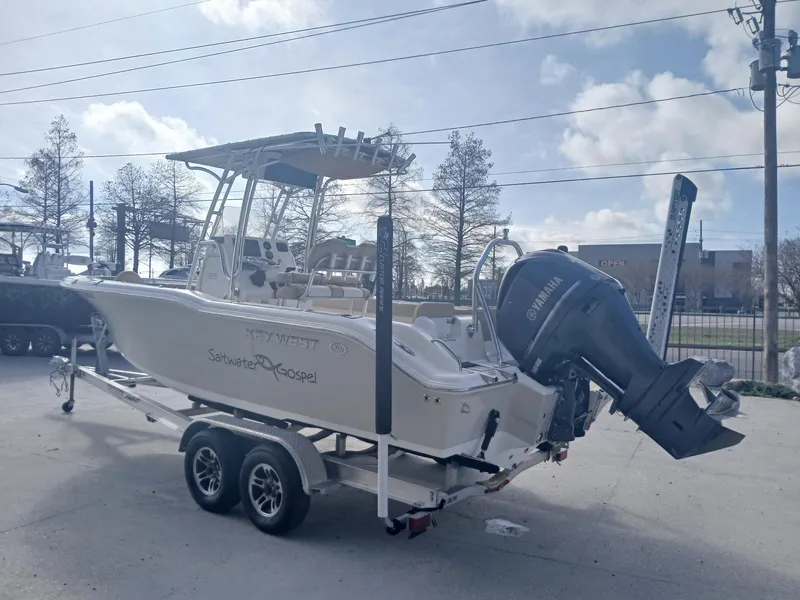 Slide: The Image of 2020 Key West 239 boat on trailer with Yamaha outboard motor, parked outdoors. - 11
