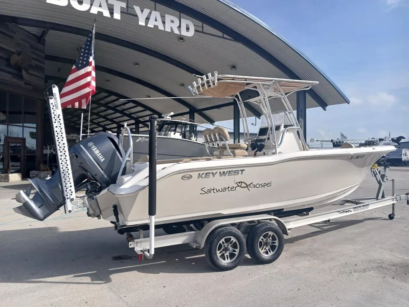 Slide: The Image of 2020 Key West 239 boat on trailer at boat yard with American flag. - 12