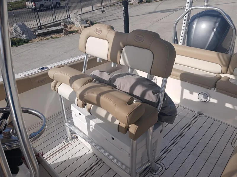 Slide: The Image of 2020 Key West 239 boat interior with beige seating and storage compartments. - 4