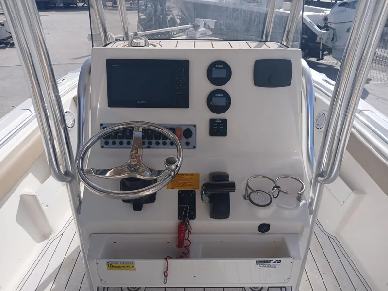 Slide: The Image of 2020 Key West 239 boat console with steering wheel and navigation controls. - 5
