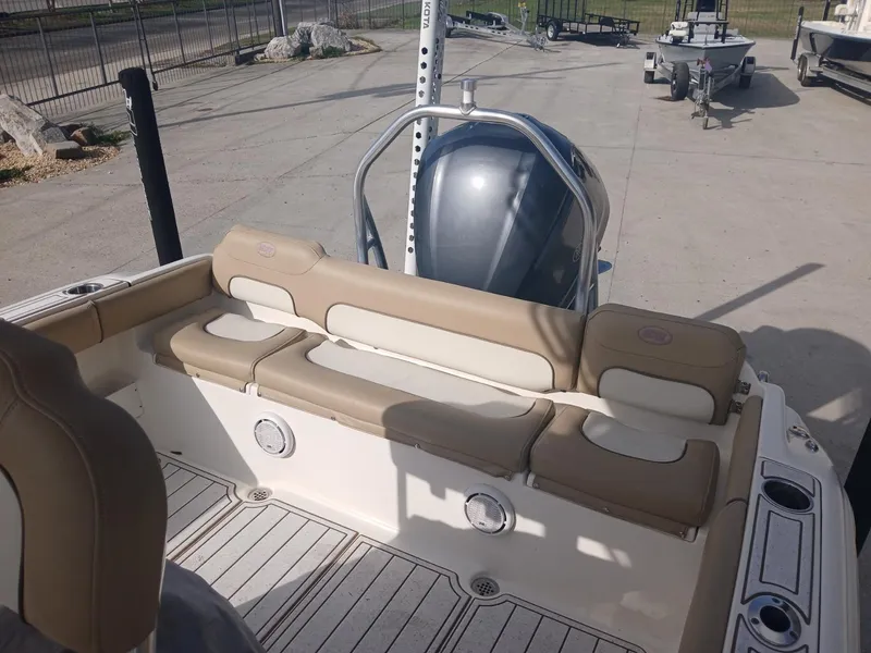 Slide: The Image of 2020 Key West 239 boat interior with beige seating and outboard motor. - 6