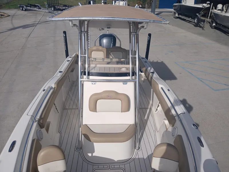 Slide: The Image of 2020 Key West 239 boat with beige seating and T-top, docked on concrete. - 7