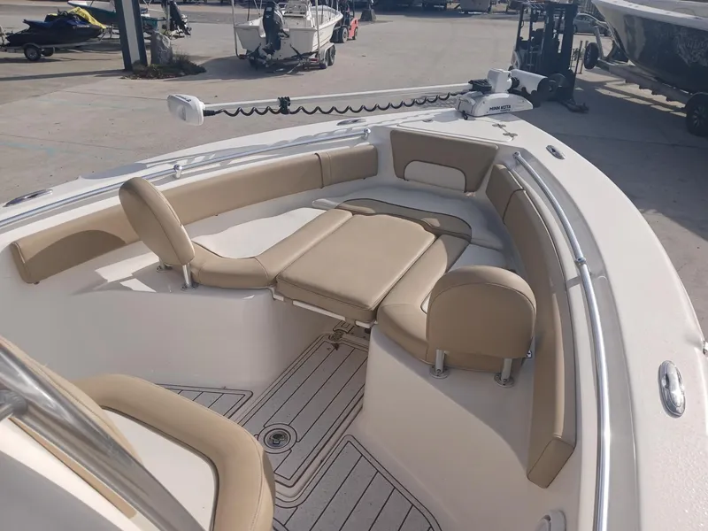 Slide: The Image of 2020 Key West 239 boat interior with beige seating and spacious deck layout. - 8