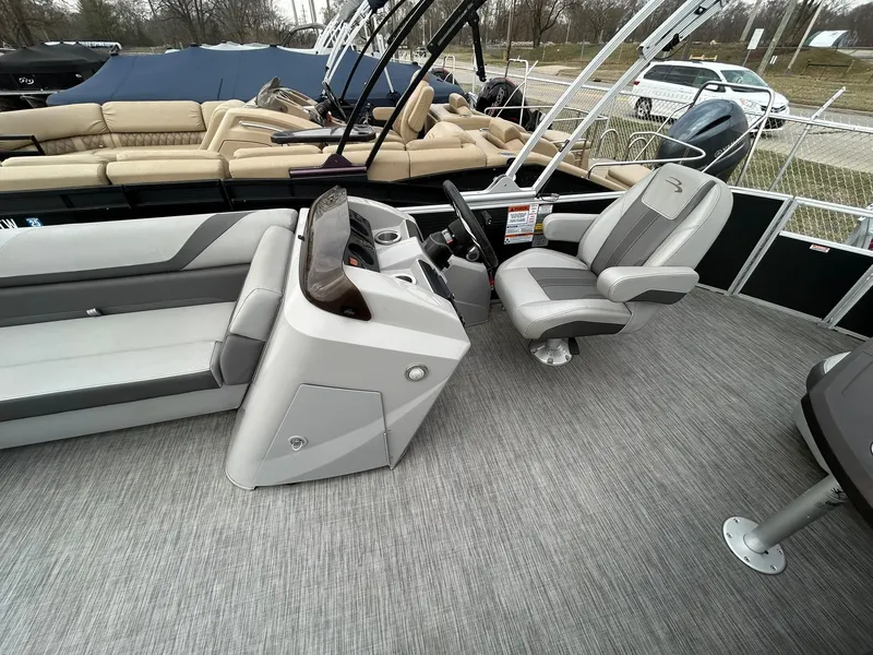 Slide: The Image of 2021 Bennington 21SLX pontoon boat interior with captain's chair and console. - 11