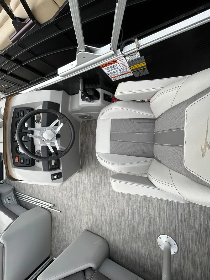 Slide: The Image of 2021 Bennington 21SLX boat interior with gray seating and steering console. - 12