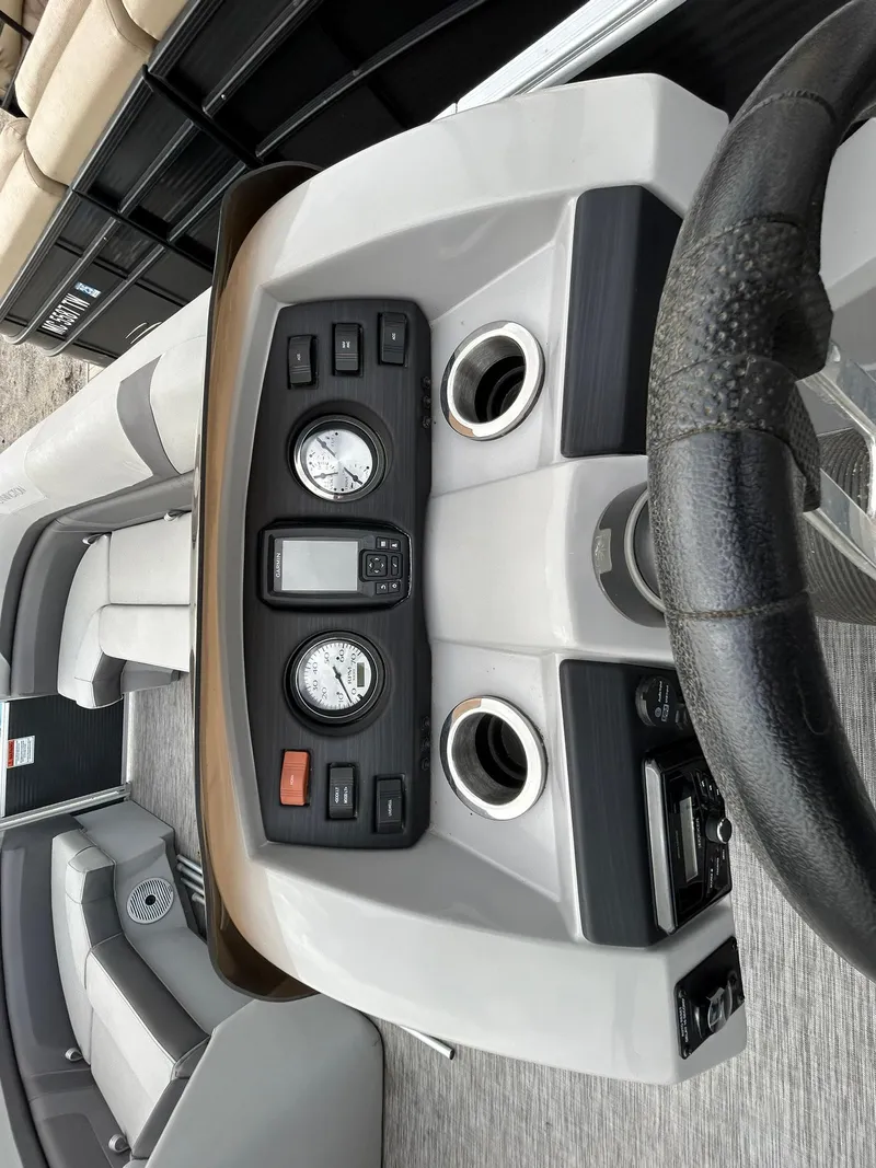 Slide: The Image of 2021 Bennington 21SLX boat dashboard with gauges and steering wheel. - 13