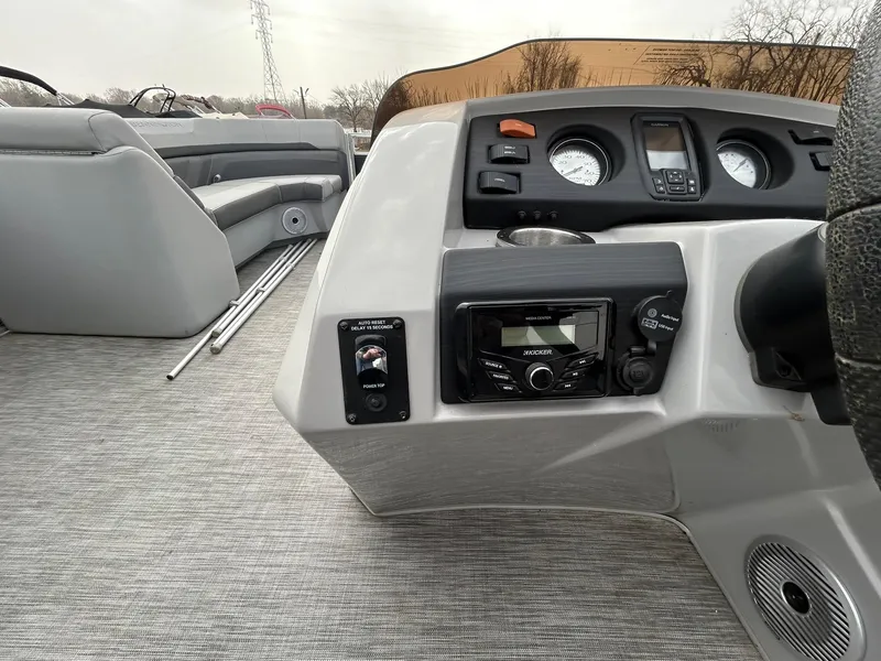 Slide: The Image of 2021 Bennington 21SLX boat interior with dashboard controls and seating area. - 14