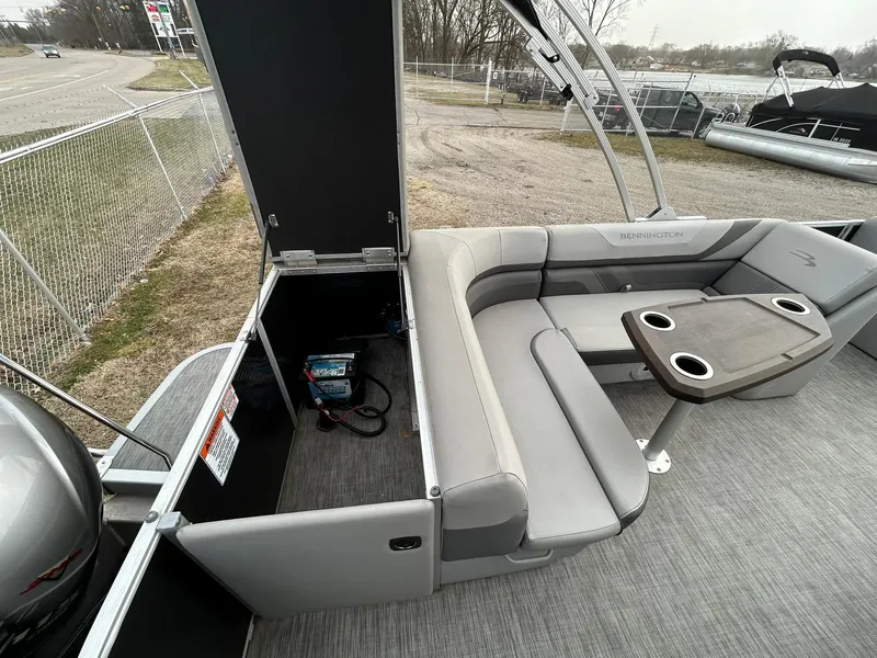 Slide: The Image of 2021 Bennington 21SLX pontoon boat interior with gray seating and table. - 16