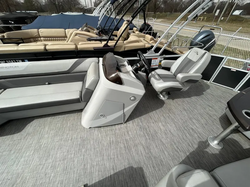 Slide: The Image of 2021 Bennington 21SLX pontoon boat interior with gray seating and helm. - 19