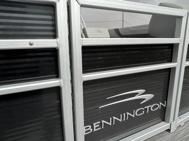 Slide: The Image of 2021 Bennington 21SLX pontoon boat with sleek design and logo detail. - 2