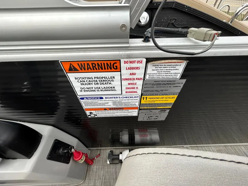 Slide: The Image of Warning labels on 2021 Bennington 21SLX boat, highlighting safety precautions and operating instructions. - 21