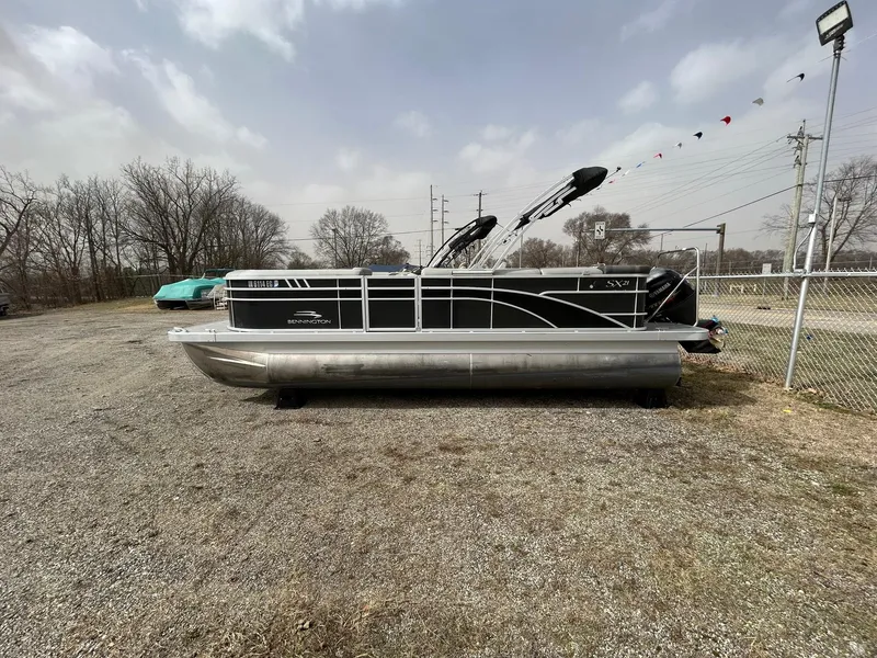 Slide: The Image of 2021 Bennington 21SLX pontoon boat parked on gravel lot, overcast sky. - 4