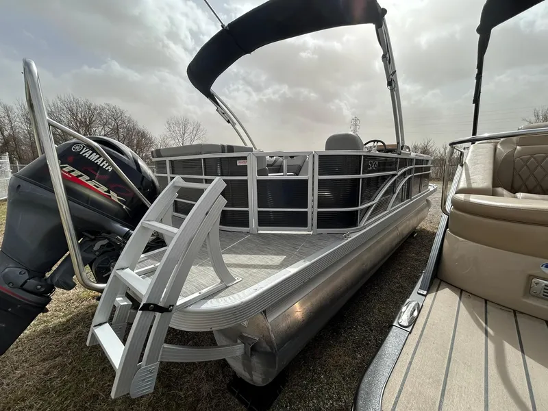 Slide: The Image of 2021 Bennington 21SLX pontoon boat with Yamaha motor, docked outdoors. - 6