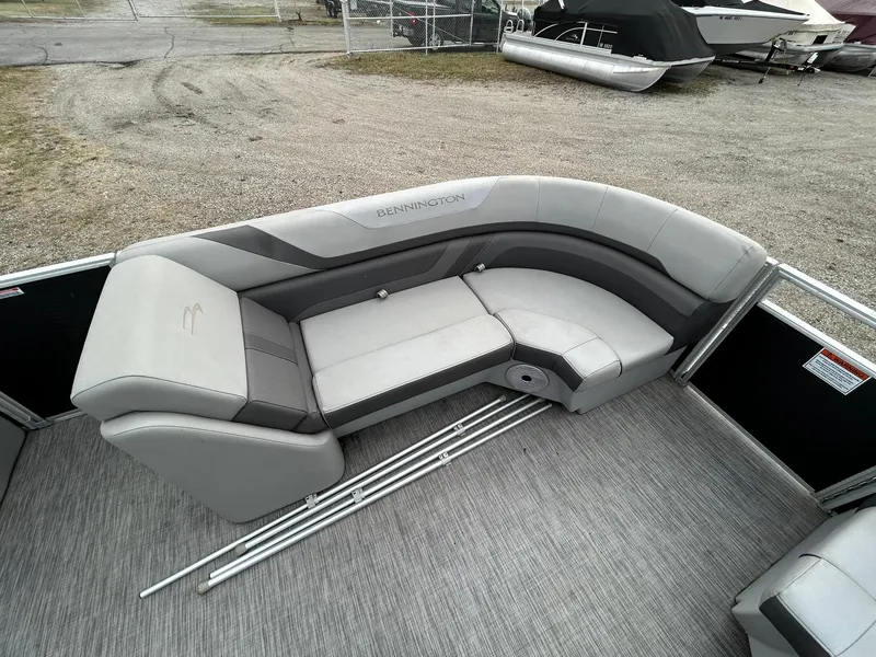 Slide: The Image of 2021 Bennington 21SLX pontoon boat with gray seating and spacious deck layout. - 8