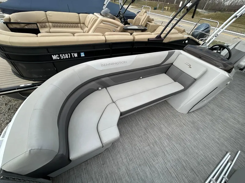 Slide: The Image of 2021 Bennington 21SLX pontoon boat with gray seating and sleek interior design. - 9