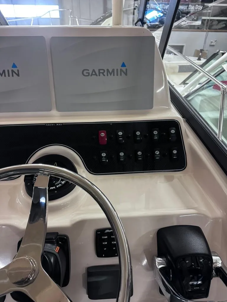 Slide: The Image of 2018 Grady-White Marlin 300 helm with Garmin navigation system and control panel. - 11