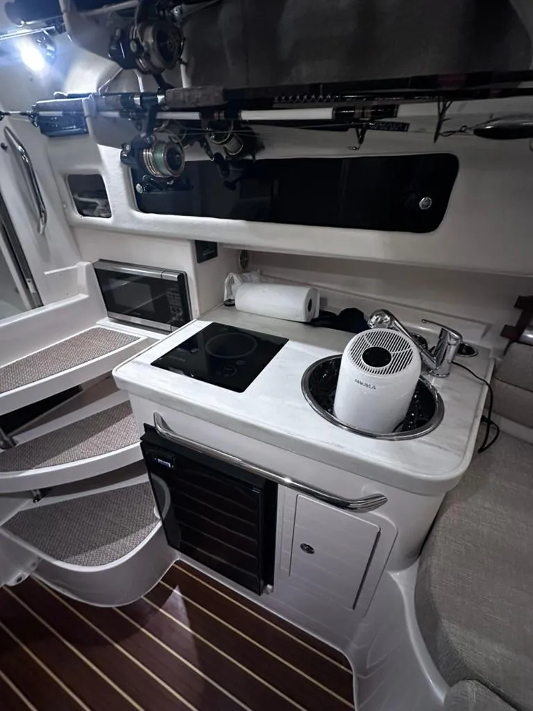 Slide: The Image of 2018 Grady-White Marlin 300 boat interior with kitchenette and modern amenities. - 14