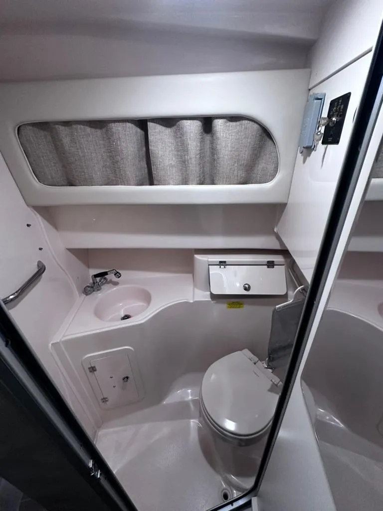 Slide: The Image of 2018 Grady-White Marlin 300 boat bathroom interior with sink and toilet. - 16