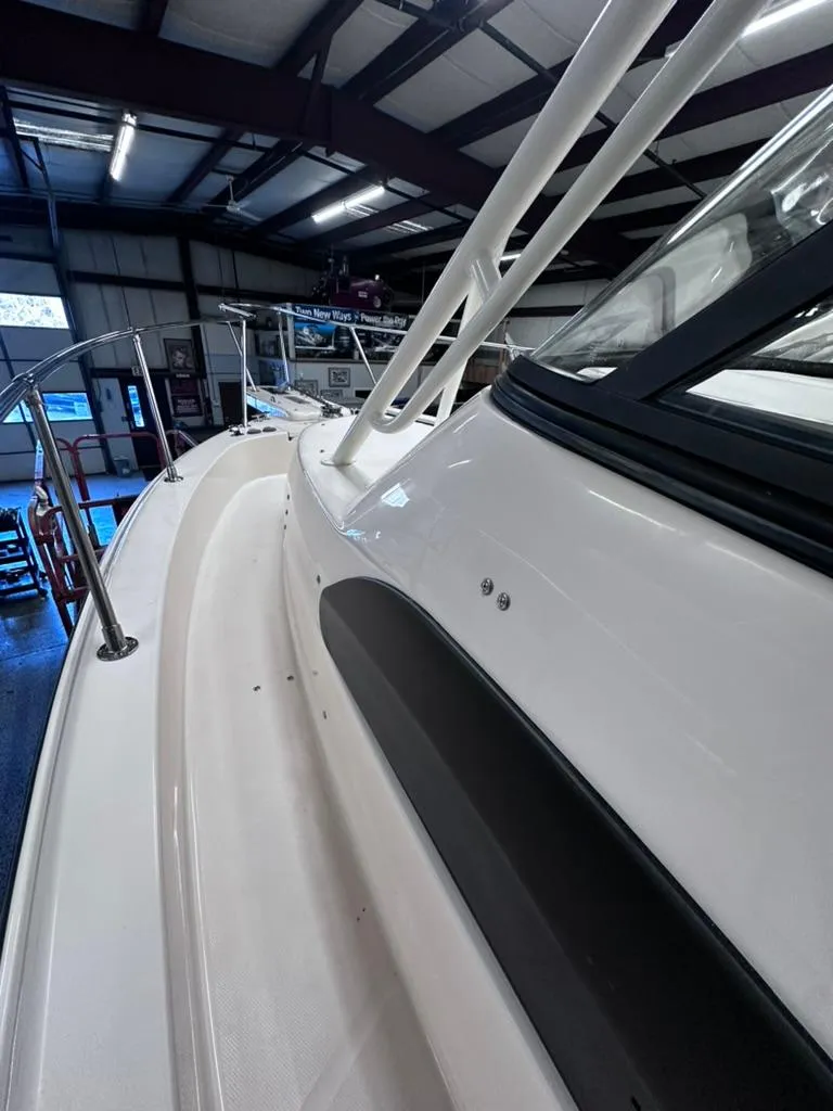 Slide: The Image of 2018 Grady-White Marlin 300 boat in showroom, showcasing sleek design and structure. - 7