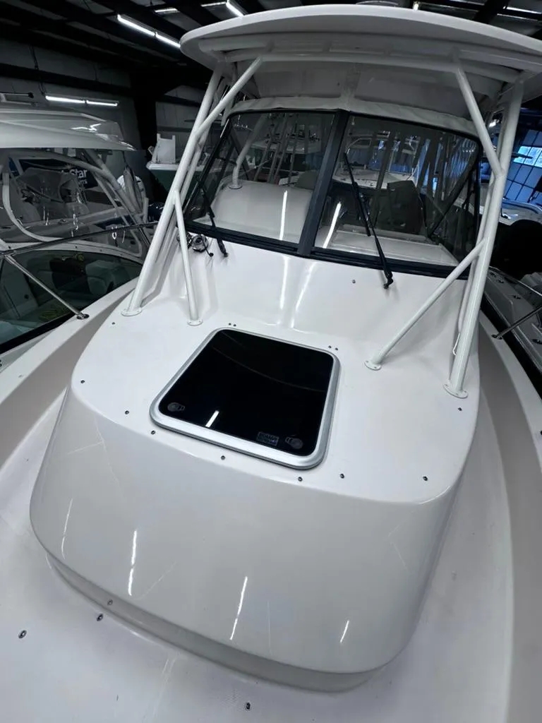 Slide: The Image of 2018 Grady-White Marlin 300 boat, white exterior, docked indoors. - 8