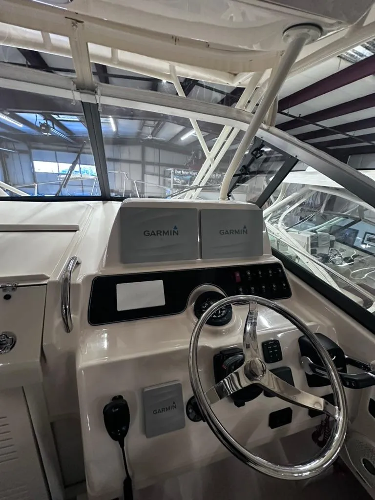 Slide: The Image of 2018 Grady-White Marlin 300 helm with Garmin navigation system in a boatyard. - 9