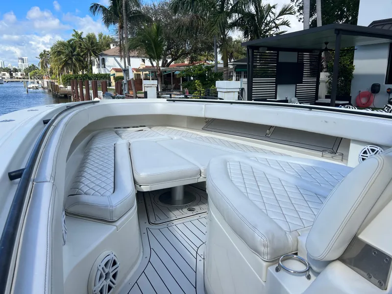 Slide: The Image of 2017 Hydra-Sports 4200 Siesta boat with luxurious seating, docked by palm trees. - 16