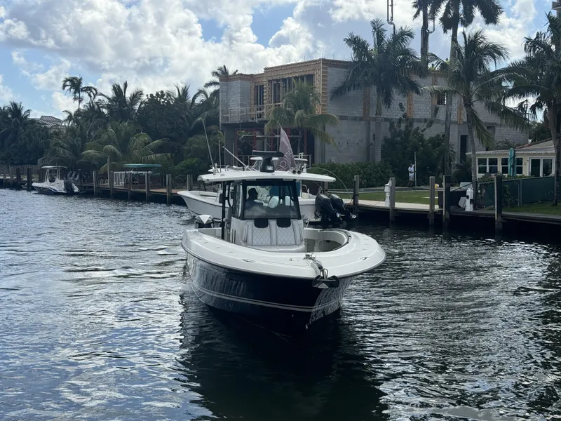 Slide: The Image of 2017 Hydra-Sports 4200 Siesta boat cruising on a scenic waterway with palm trees. - 23