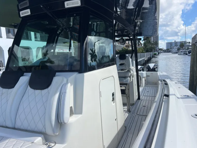 Slide: The Image of 2017 Hydra-Sports 4200 Siesta boat docked, featuring sleek design and spacious seating. - 25