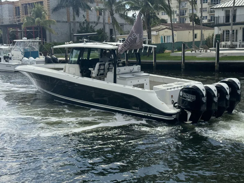 Slide: The Image of 2017 Hydra-Sports 4200 Siesta boat cruising on a waterway near docks and palm trees. - 3