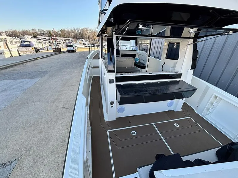 Slide: The Image of Navan C30 2025 boat docked, featuring spacious deck and modern design elements. - 10