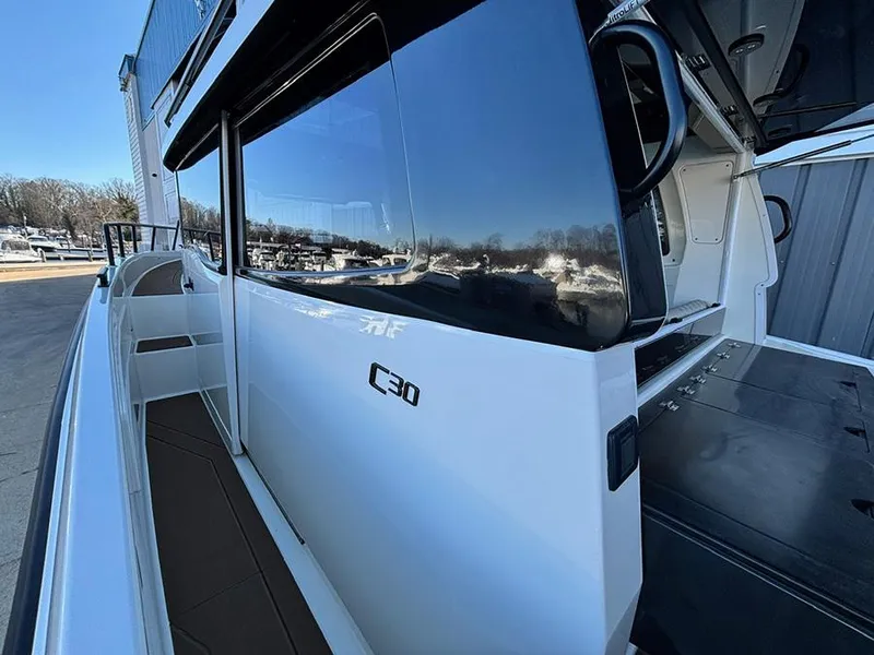 Slide: The Image of 2025 Navan C30 boat exterior with sleek design and reflective windows. - 11