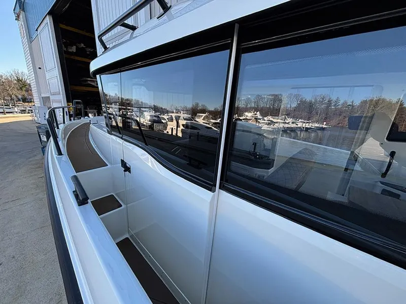 Slide: The Image of Navan C30 2025 boat docked, showcasing sleek design and reflective windows. - 12