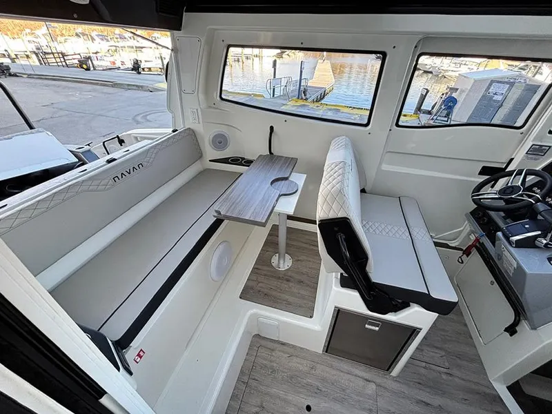 Slide: The Image of Interior of 2025 Navan C30 boat with seating, table, and steering area. - 13