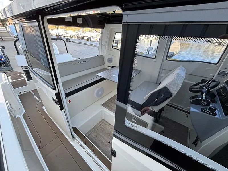 Slide: The Image of 2025 Navan C30 boat interior with modern seating and control panel, dockside view. - 15
