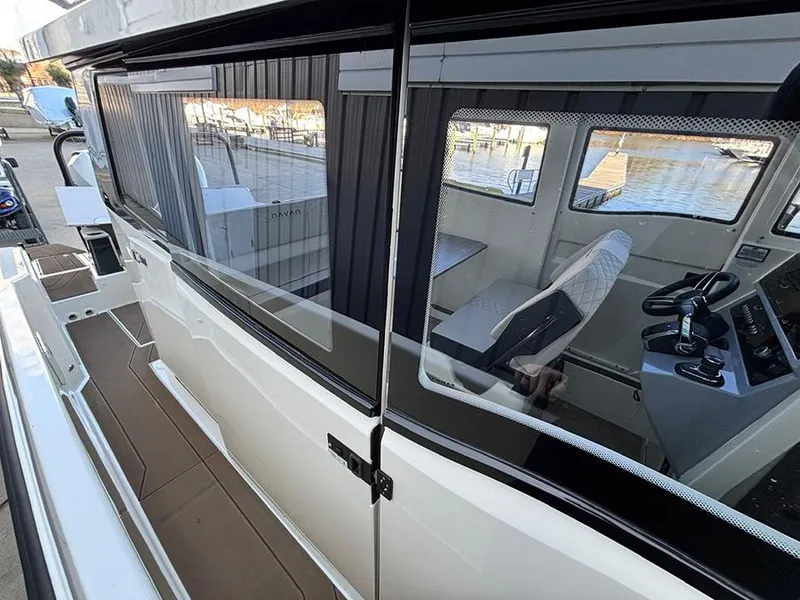 Slide: The Image of Navan C30 2025 boat interior with modern cockpit and waterfront view. - 16