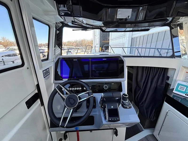 Slide: The Image of 2025 Navan C30 boat cockpit with modern steering wheel and digital controls. - 21