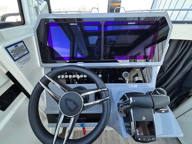 Slide: The Image of Steering console of 2025 Navan C30 boat with dual Simrad displays and modern controls. - 22