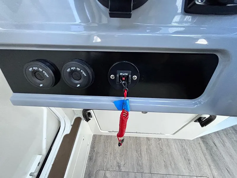 Slide: The Image of Control panel of 2025 Navan C30 boat with ignition switch and safety lanyard. - 24