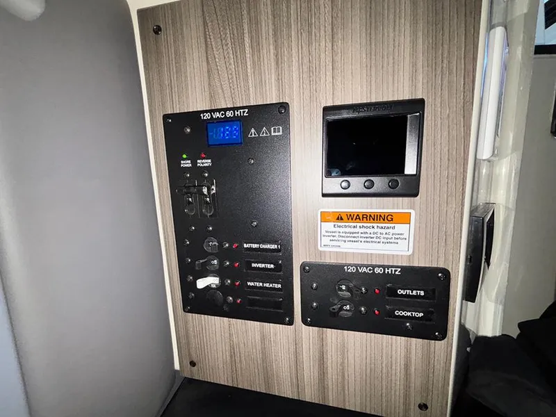 Slide: The Image of Control panel of Navan C30 2025 with electrical switches and warning label. - 34