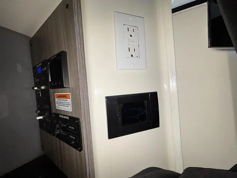 Slide: The Image of Control panel and electrical outlet in 2025 Navan C30 interior. - 35