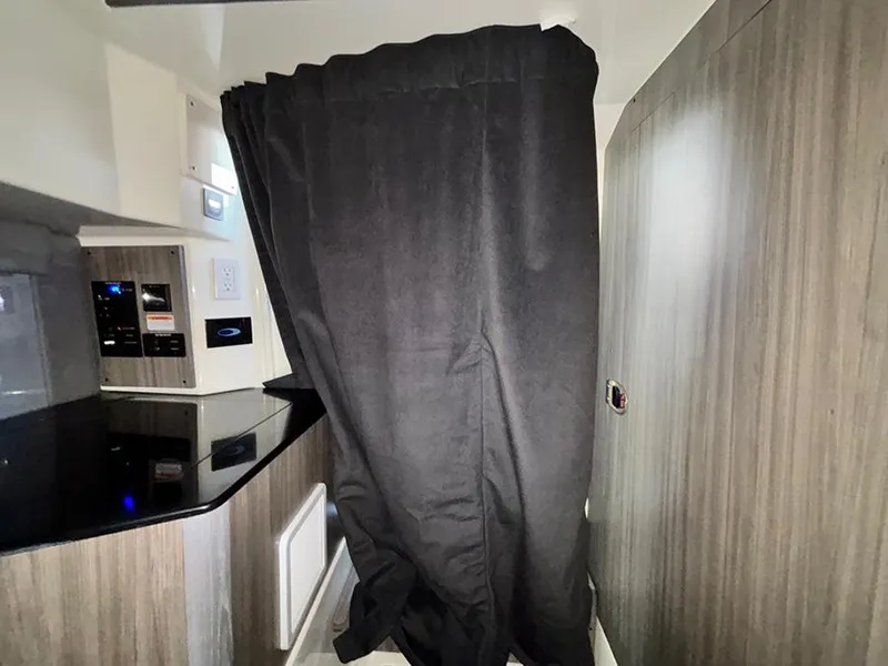 Slide: The Image of Interior of 2025 Navan C30 with black curtain and modern kitchen area. - 37