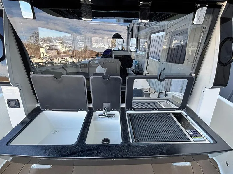 Slide: The Image of Outdoor kitchen setup on a 2025 Navan C30 boat with sink and grill. - 7
