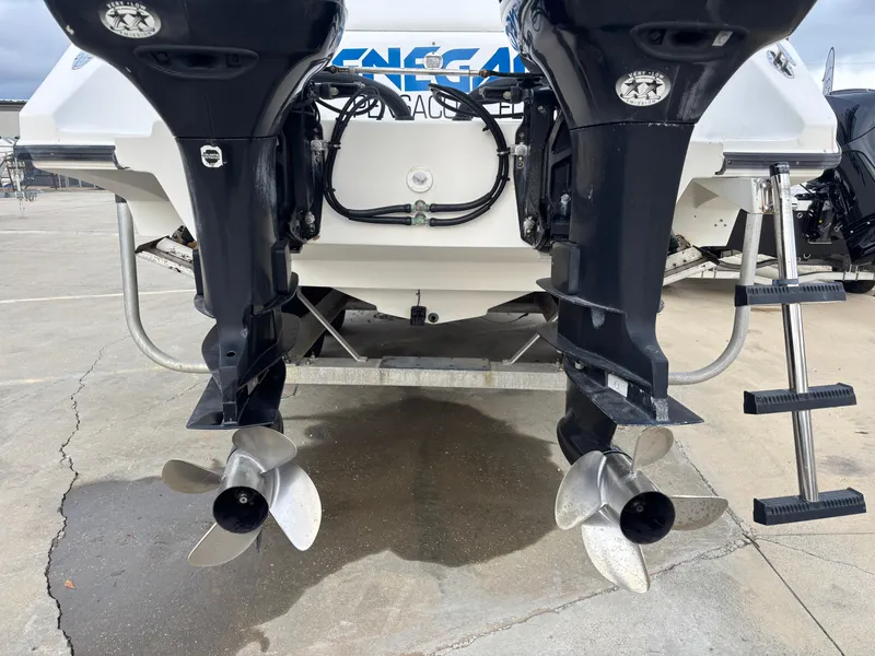 Slide: The Image of 1997 Jefferson Marlago 35 FS boat with dual outboard motors and propellers. - 12