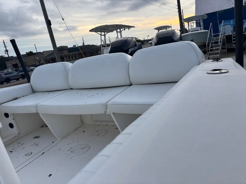 Slide: The Image of 1997 Jefferson Marlago 35 FS boat with white seating, parked outdoors under cloudy sky. - 17