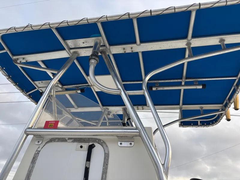 Slide: The Image of 1997 Jefferson Marlago 35 FS boat with blue canopy and metal framework. - 19