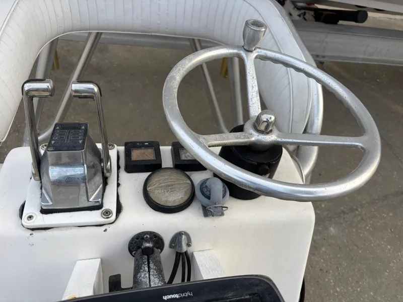 Slide: The Image of Steering console of a 1997 Jefferson Marlago 35 FS boat with controls and gauges. - 22