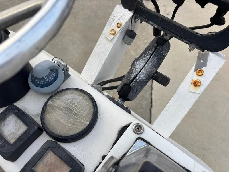 Slide: The Image of Control panel of a 1997 Jefferson Marlago 35 FS boat with compass and gauges. - 24